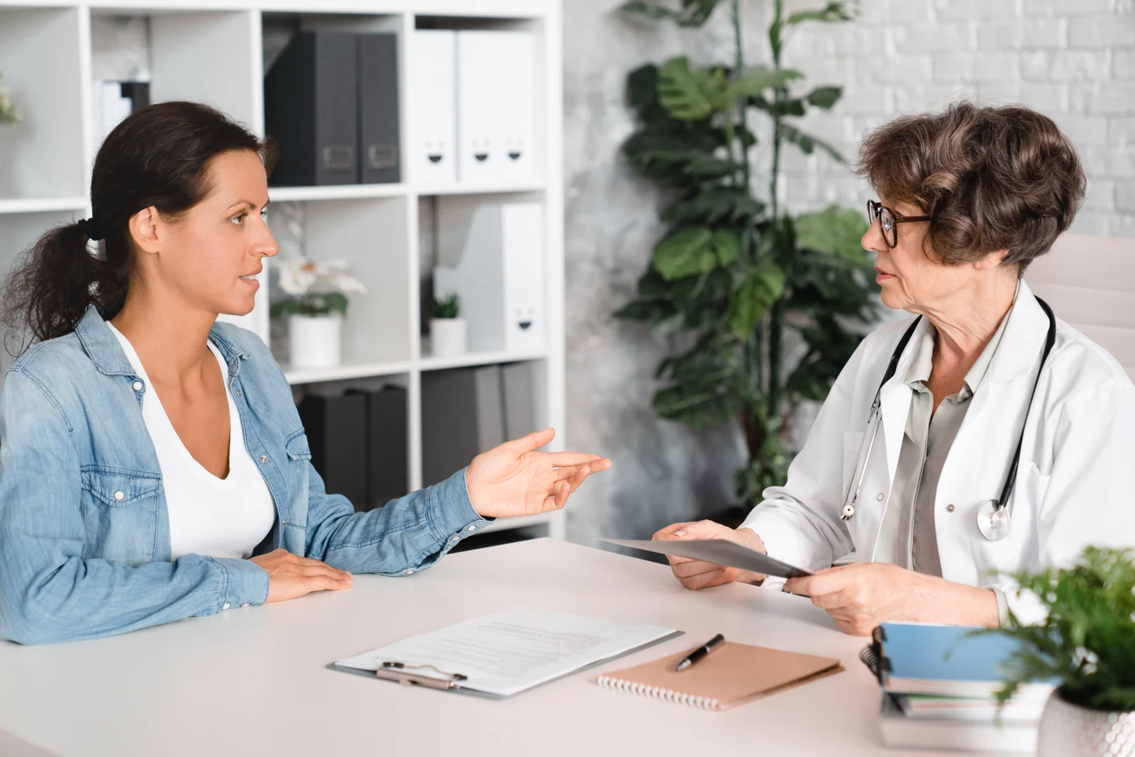 Woman Talking With Doctor in Modern Office Setting