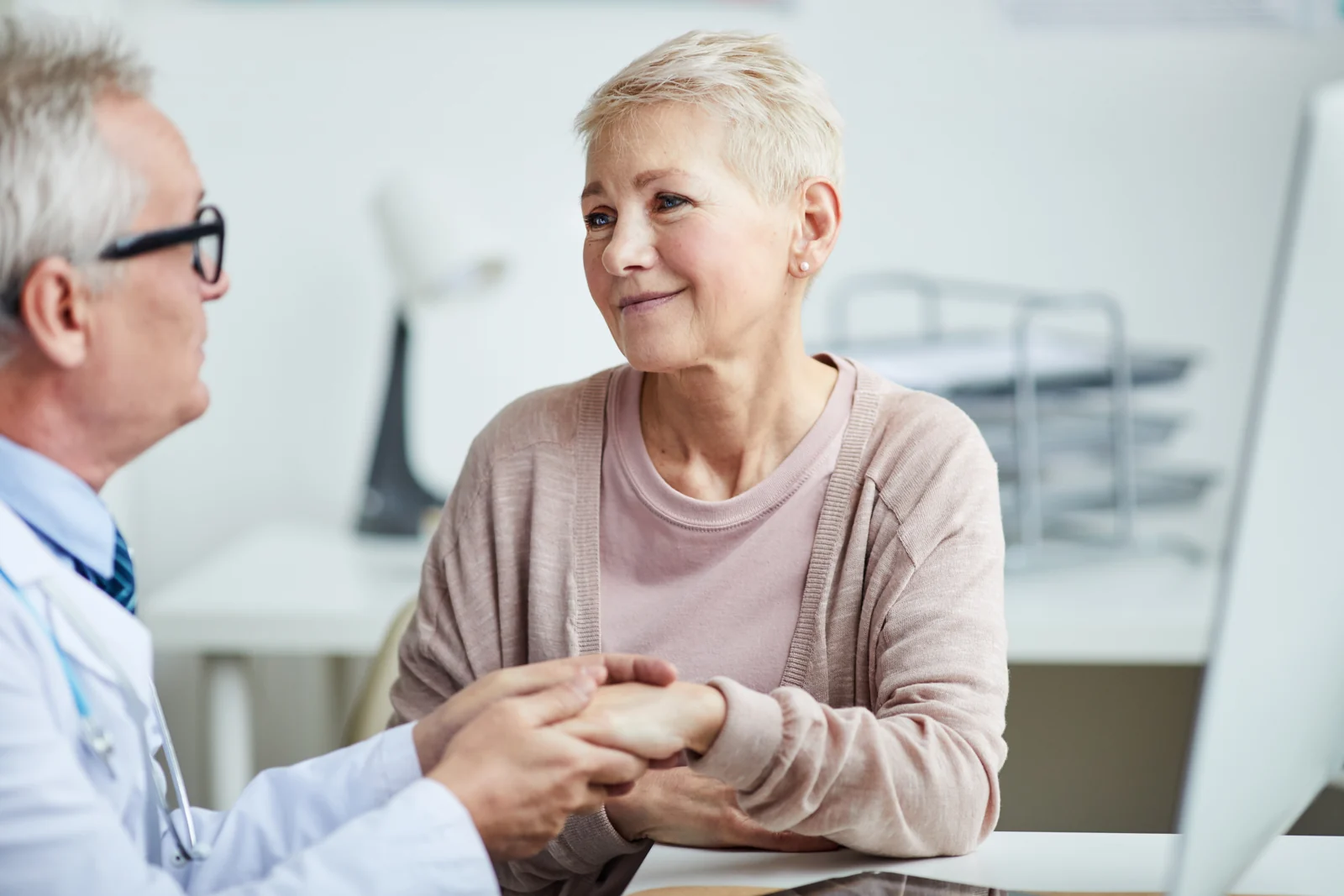 Mature Woman Receiving Compassionate Care from Doctor